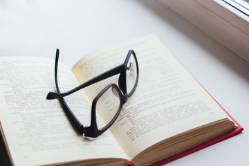 Glasses on the pages of an open book.