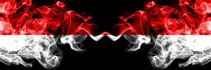 Obraz premium Indonesia vs Indonesia, Indonesian smoky mystic flags placed side by side. Thick colored silky smoke flags of Indonesia and Indonesia, Indonesian