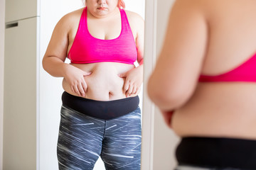 plus size girl pinch her waist
