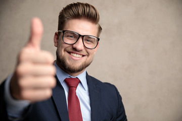 Cheerful businessman gesturing ok and smiling