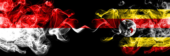 Indonesia vs Uganda, Ugandan smoky mystic flags placed side by side. Thick colored silky smoke flags of Indonesia and Uganda, Ugandan