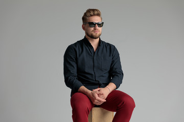 Fototapeta premium Neutral casual man looking away and holding his hands