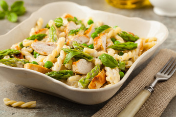 Italian pasta fusilli. Salad with chicken and asparagus in Béchamel sauce.