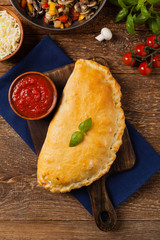 Italian calzone with mushrooms and ham. Top view.