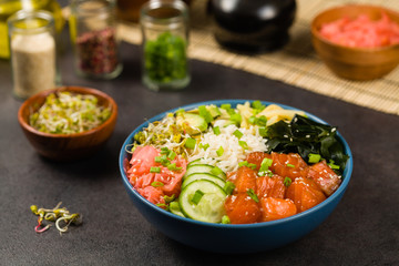 Hawaiian salmon poke bowl with seaweed, avocado, sesame seeds.