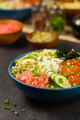 Hawaiian salmon poke bowl with seaweed, avocado, sesame seeds.