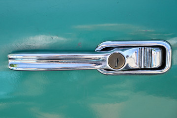 A chrome handle from a vintage car.