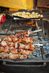 Barbecue fries in the coals. Meat and beef at the field kitchen festival.