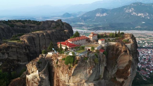 Aerial view of a slide from a drone on a panorama of a mountain range. Kalambaka city, Greece. The tops rocks of Meteora. Orthodox monastery in the mountains of Meteora. Monastery of the Holy Trinity