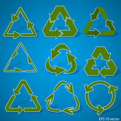 Set of various green recycle symbols on blue background