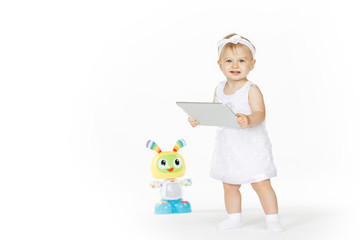 little girl all in white with tablet and toy