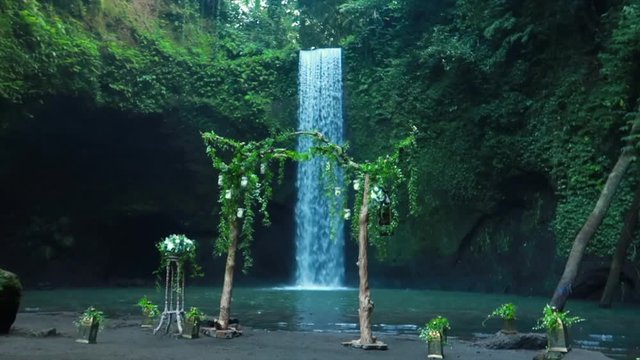 Timbumana Waterfall In A Secluded Jungle With A Perfect Bridal Veil Into A Pool in Ubud, Bali, Indonesia - With Wedding Arch or Arbor