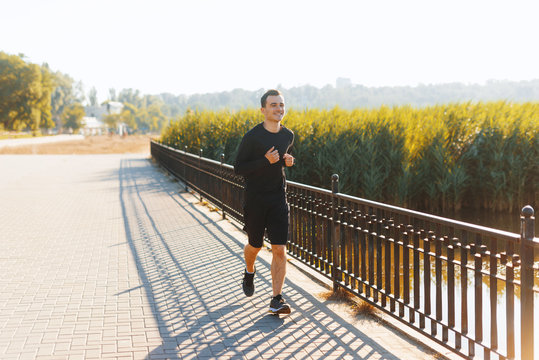 Photo of  someone young man, running inn park, on the morning sunlight, sport concept