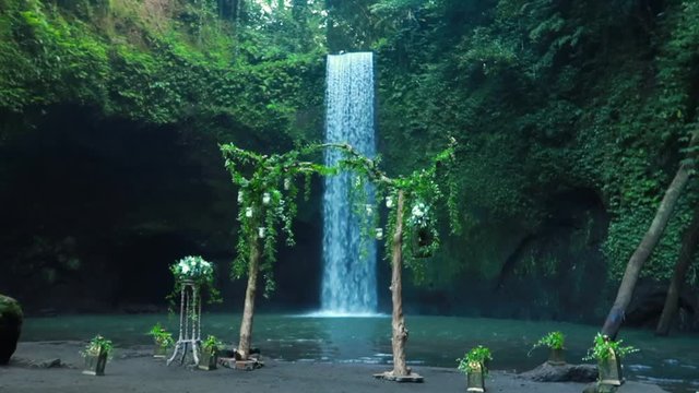 Timbumana Waterfall In A Secluded Jungle With A Perfect Bridal Veil Into A Pool in Ubud, Bali, Indonesia - With Wedding Arch or Arbor