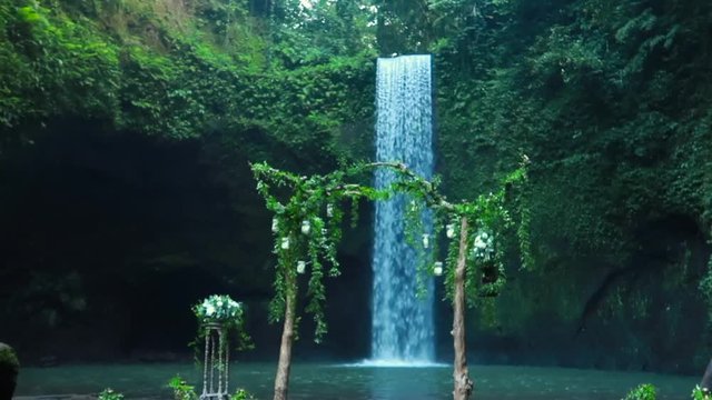 Timbumana Waterfall In A Secluded Jungle With A Perfect Bridal Veil Into A Pool in Ubud, Bali, Indonesia - With Wedding Arch or Arbor