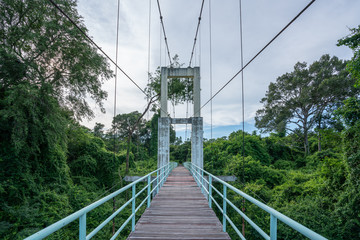 Obraz premium Beautiful of the longest suspension bridge in North eastern Region at Tana Rapids National Park,Ubonratchatani, Thailand