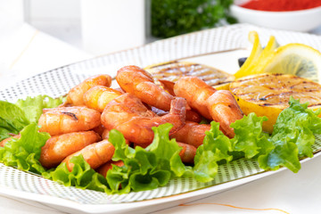 Grilled prawns with lemon grill on white plate