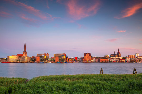 Rostock, Germany. Cityscape image of Rostock riverside with St. Peter's Church during summer sunset.