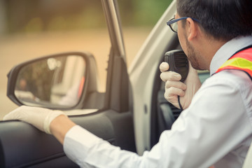 Male using walkie-talkie with colleague in the car rescuer on road