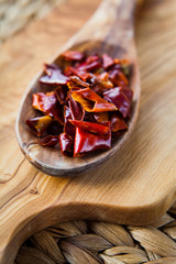 Dried Red Chili -  Hot Spices, macro on wooden spoon.