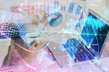 Double exposure of businessman working on laptop on background. International business hologram in front. Concept of success.