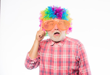 Nice joke. Elderly clown. Man senior bearded cheerful person wear colorful wig and sunglasses. Grandpa always fun. Having fun. Funny lifestyle. Fun and entertainment. Comic grandfather concept