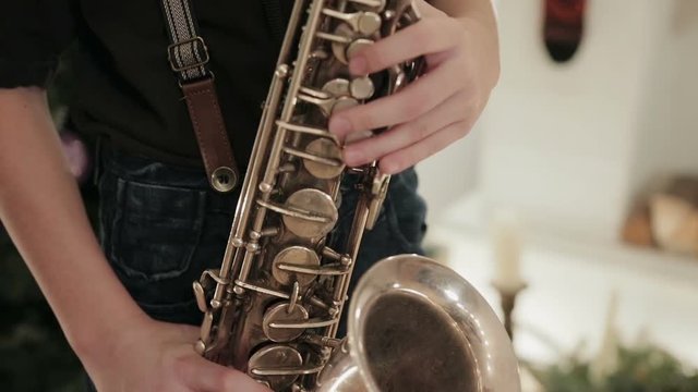 The boy in the black shirt playing the saxophone and your saxophone closeup