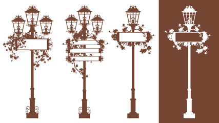 set of vintage looking iron street lights with blank information banners among autumn maple foliage - fall season urban silhouette vector design set