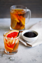 Refreshing healthy cocktail of fermented raw kombucha tea with a slice of grapefruit and ices.Kombucha mushroom tea is a natural fermented drink originally from China.Vertical orientation