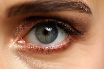 Obraz premium Amazing female emerald wide opened green coloured left eye