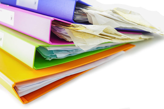 File Folder Binder stack of multi color on table in office.