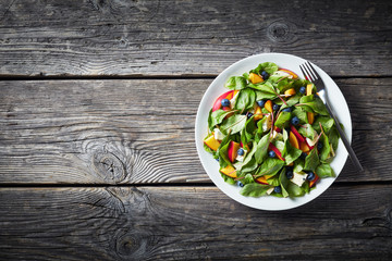 summer salad with chard, cheese. peach, berries