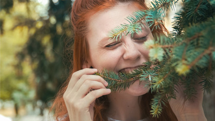 Smiling girl wants to taste greens. Caricature of healthy eating. Unusual behavior outdoor....