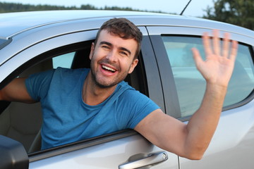 Nice man greeting someone while driving