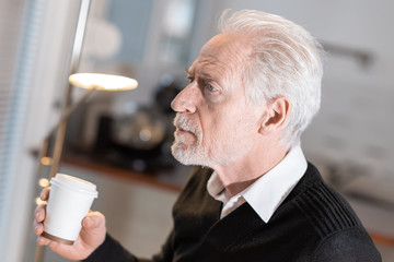 Thoughtful senior man during coffee break
