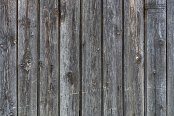 old peeling wooden boards. Background natural wooden boards. Texture of old unpainted wooden planks. Vertical arrangement of shabby wooden boards.