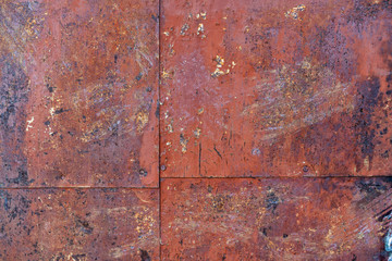 old iron wall consisting of separate pieces of metal. metal patches. Metal sheets from which the area is paint. Iron rusting.