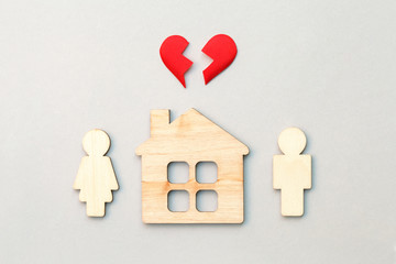 wooden house and models of man and woman with red broken heart, divorce, end of relationship and ...