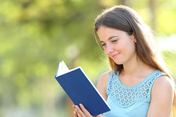 Fototapeta premium Serious woman reading a book on green background