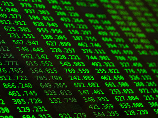 Concept of Financial data on a monitor. Display of Stock market quotes on black background.