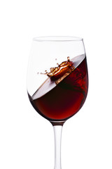 splash with crown of red wine in glass isolated on white background.