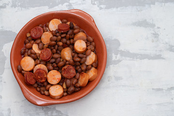 beans with smoked sausages and sausages in ceramic dish