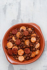 beans with smoked sausages and sausages in ceramic dish