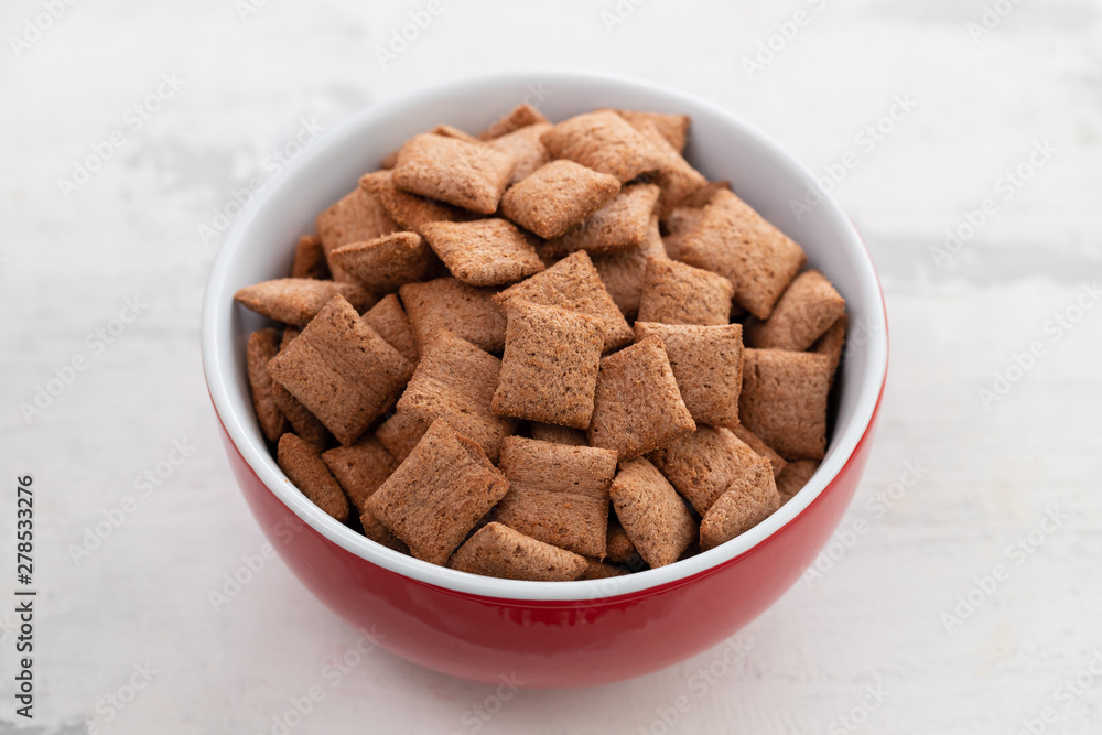 Sticker Chocolate pillows in red bowl on ceramic background