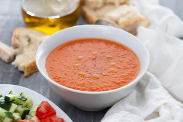 typical spanish cold spup gazpacho in white bowl on cermic background