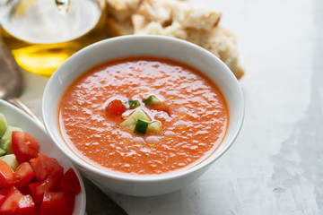 typical spanish cold spup gazpacho in white bowl on cermic background