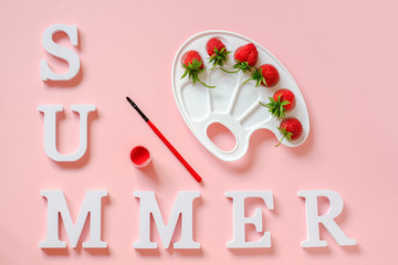 Text Summer, red ripe strawberries on artistic palette, brush and gouache on pink background. Creative concept summer colors paint Top view Flat lay Template for postcard invitation