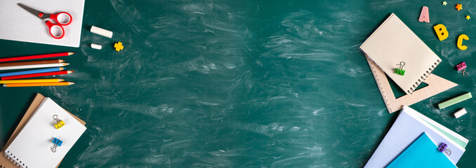 Banner. Still life with school supplies. Blackboard in chalk chalkboard. Green background....