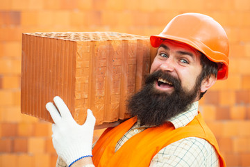 Bearded man worker, beard, building helmet, hard hat. Builders in hard hat and gloves. Portrait of...
