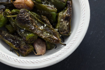 typical spanish food grilled green pepper with salt on dish